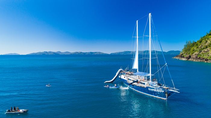 Sailing catamaran on turquoise Whitsundays water